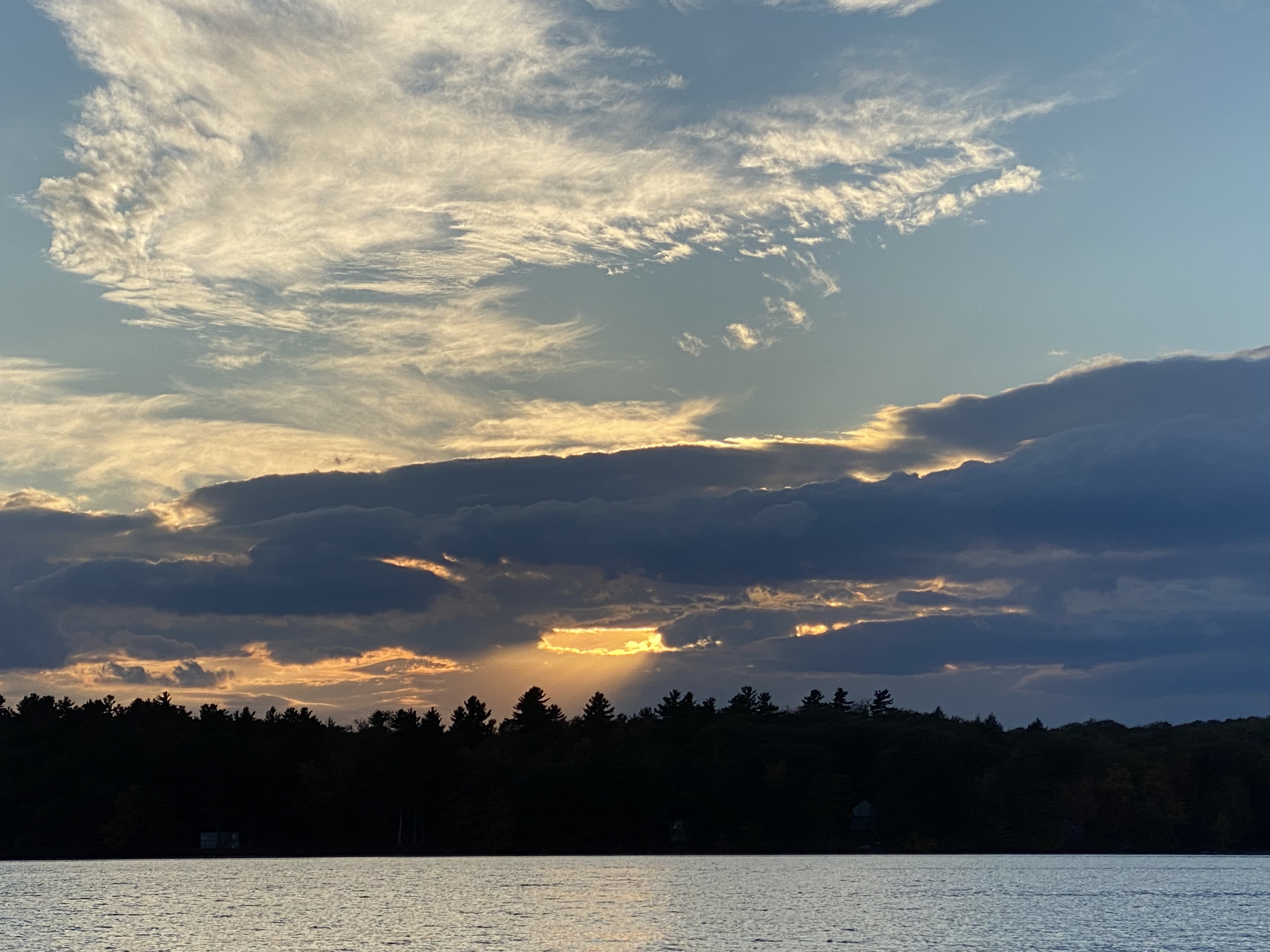 Dramatic sunset sky over the lake and treeline