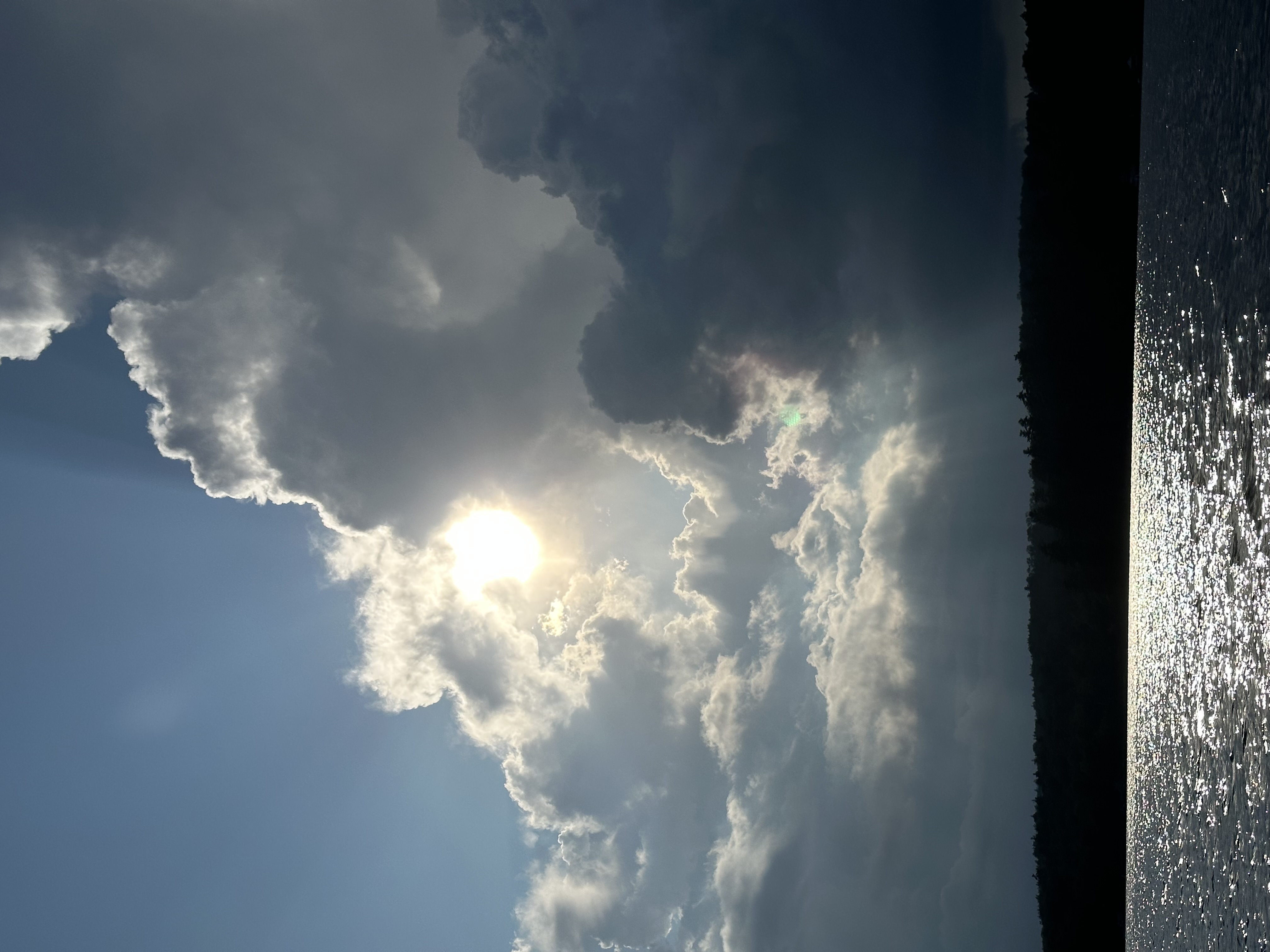 Storm clouds and sunlight over the lake