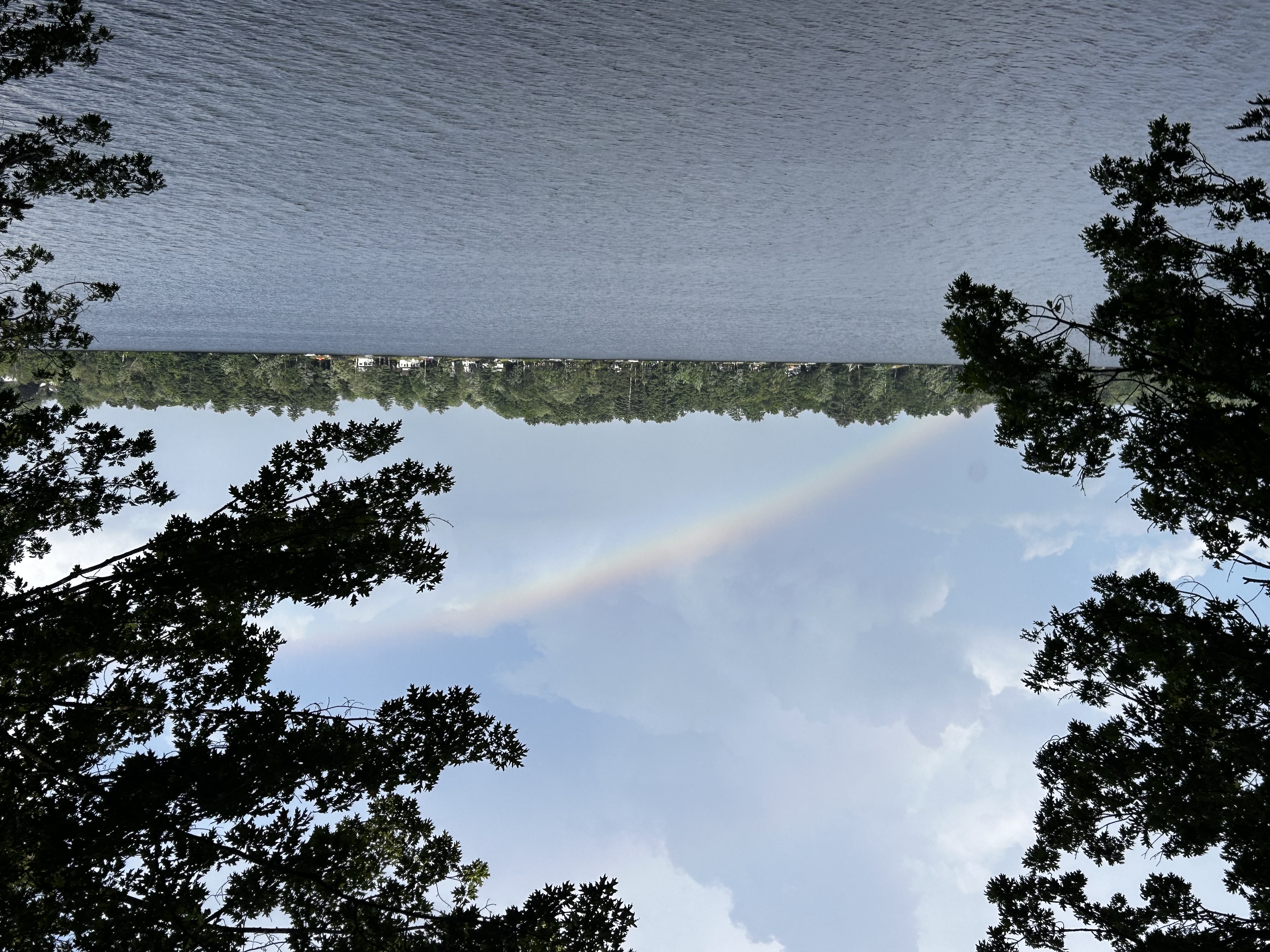 Rainbow over Cochnewagon Lake framed by trees